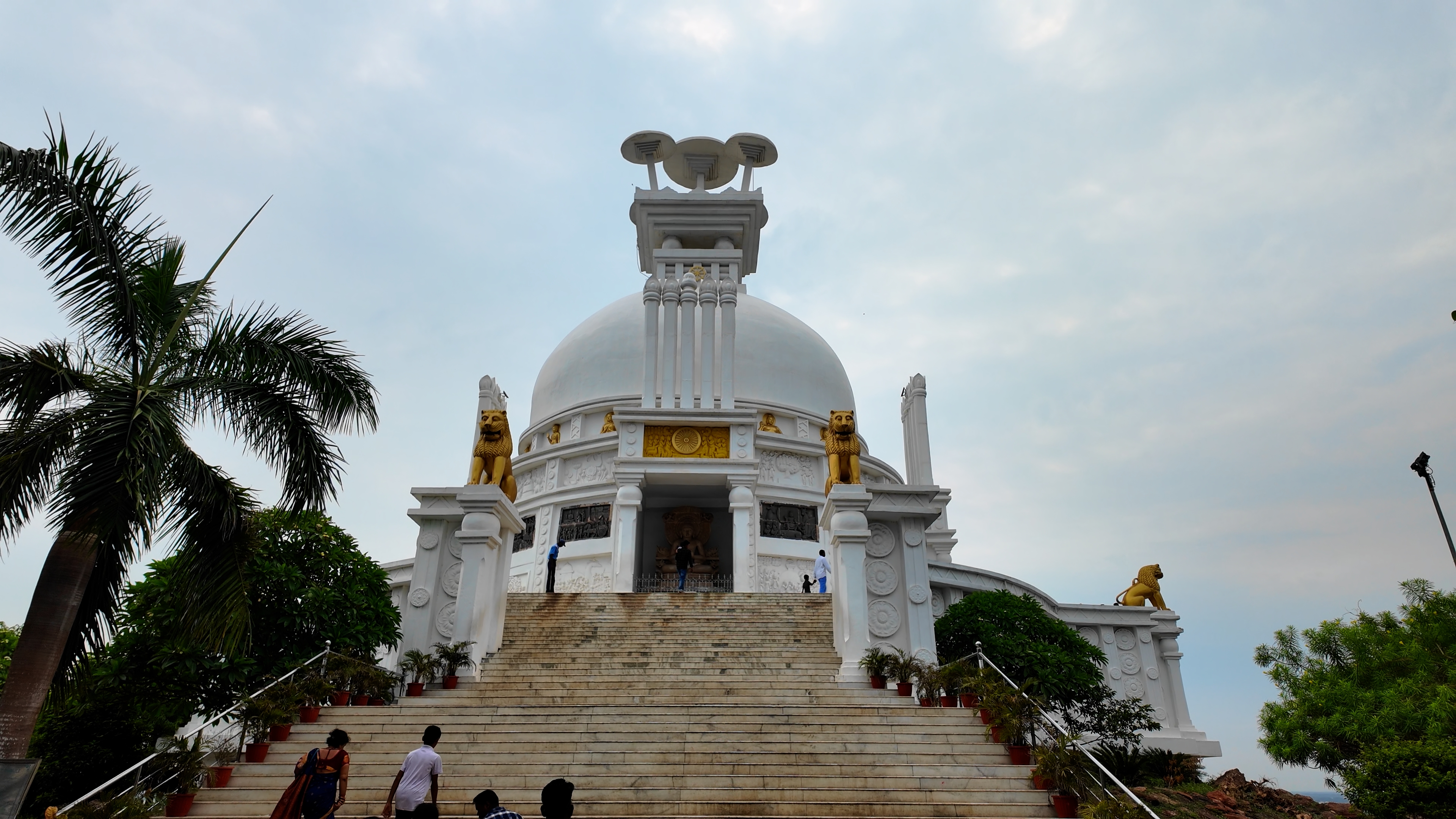 The white Dhauli Shanti Stupa standing on the hilltop