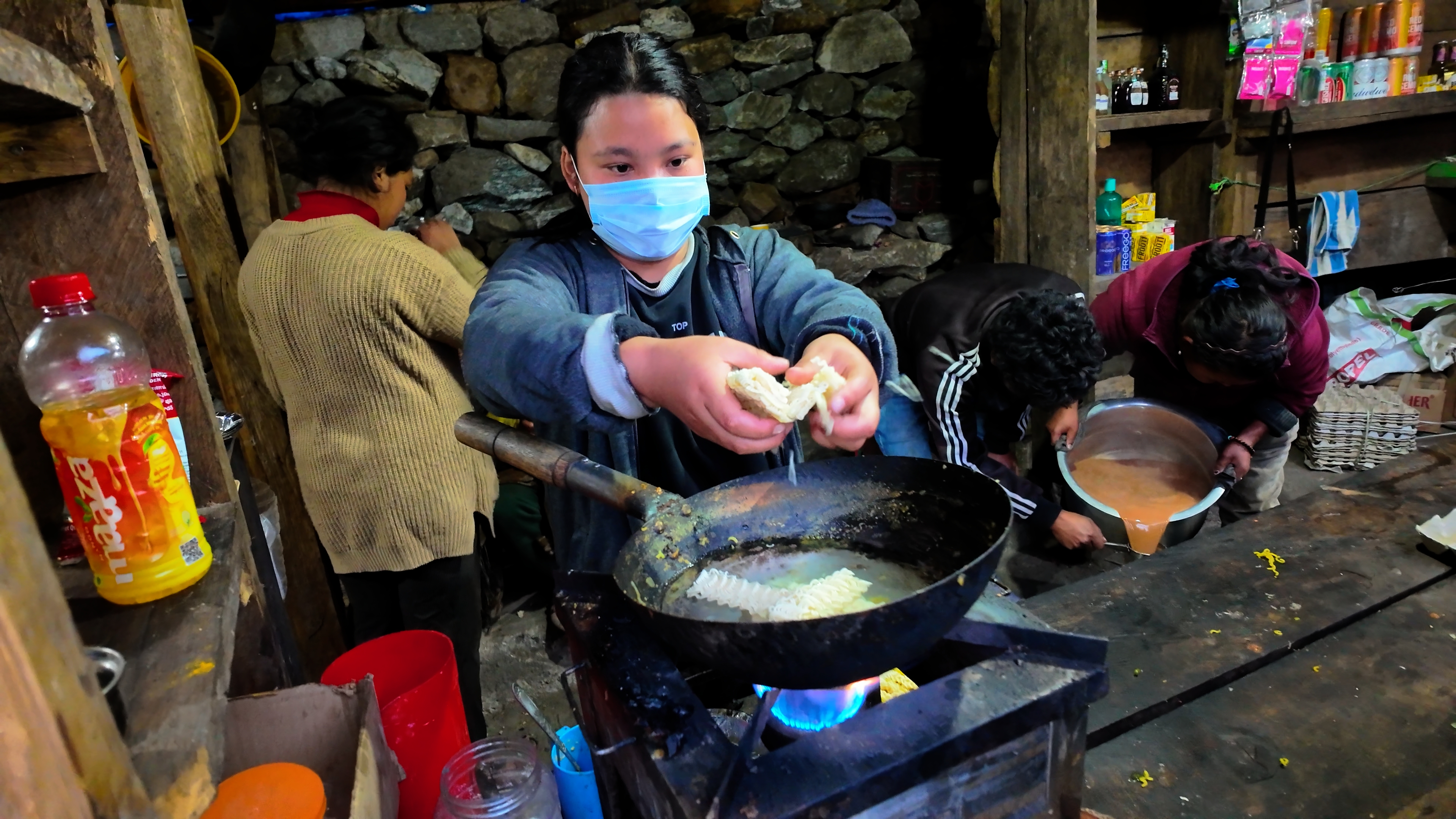 A lady preparing Maggi noodles at a roadside stall near Lachung waterfall