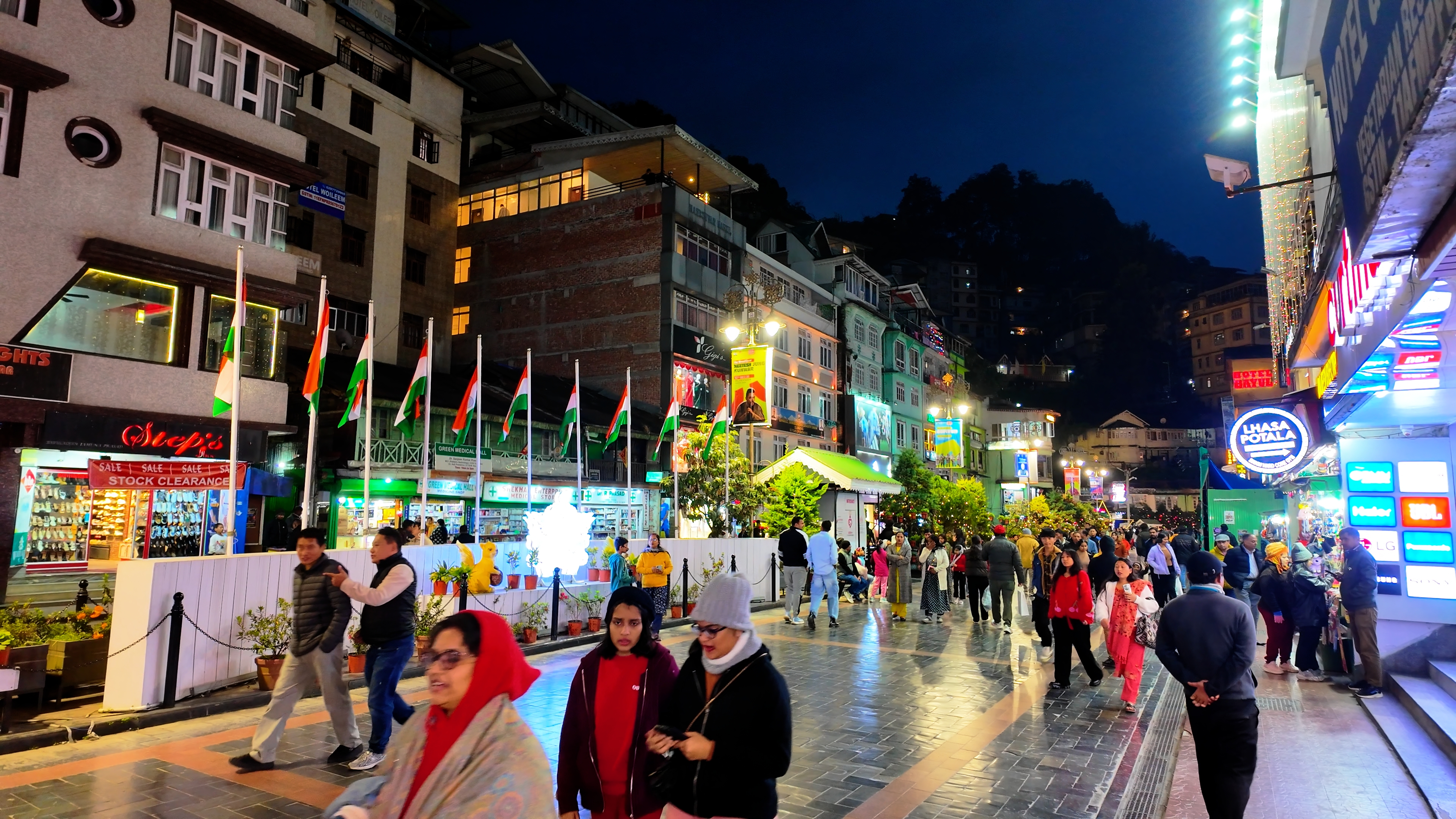 Crowds and shops along MG Road, Gangtok at night